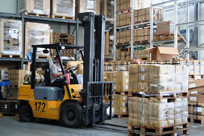 Busy warehouse with pallet trucks working